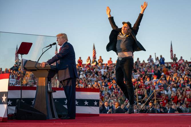 Tesla CEO Elon Musk (R) jumps on stage as he joins former US President and Republican presidential candidate Donald Trump during a campaign rally at site of his first assassination attempt in Butler, Pennsylvania 