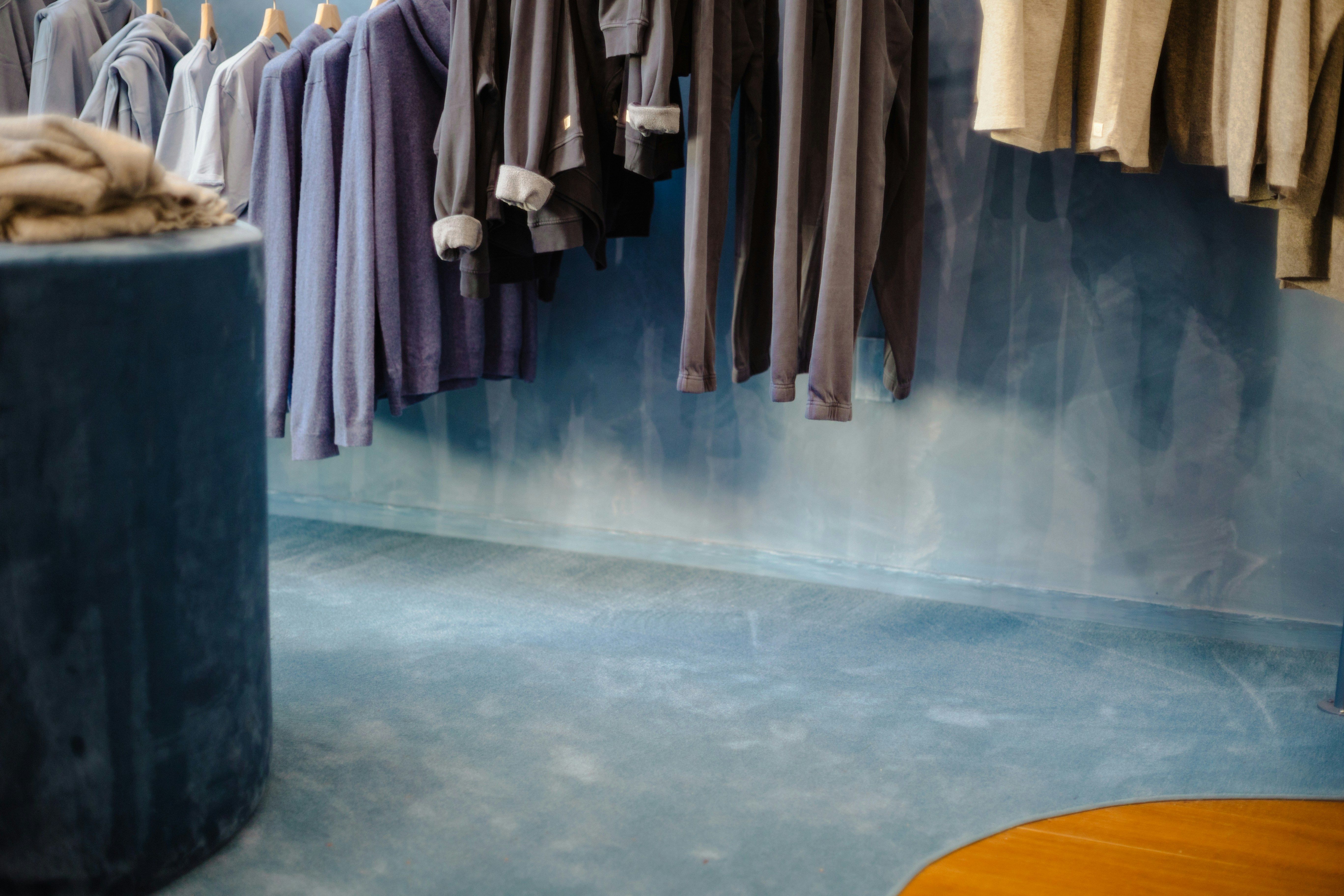 Clothing hanging in retail clothing boutique.