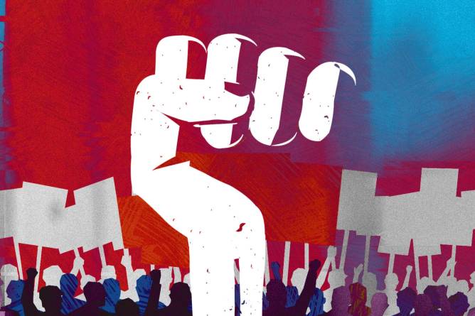 Fist raised in the air in front of picket line