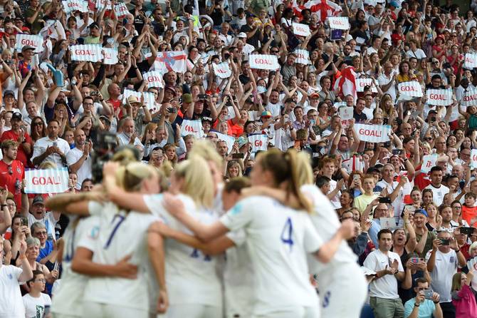 England's women's national team celebrating in front of fans