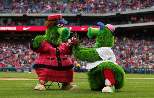 The Phillie Phanatic offers flowers to his mother Phoebe for Mother's Day during a game between the New York Mets and Philadelphia Phillies
