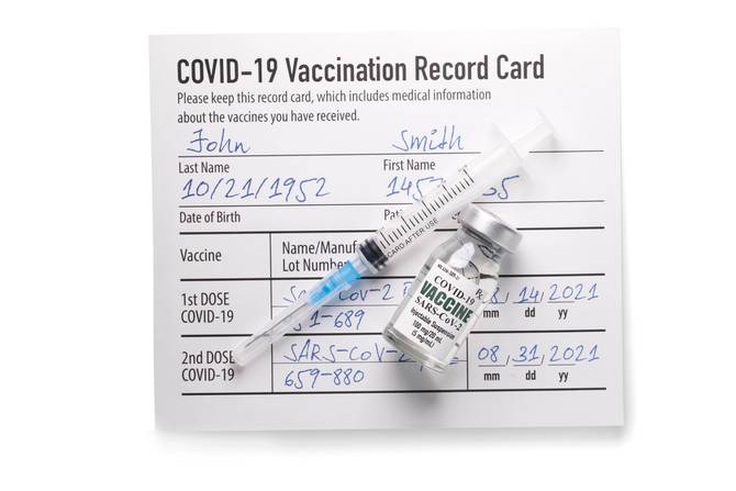 Covid-19 vaccination card and syringe
