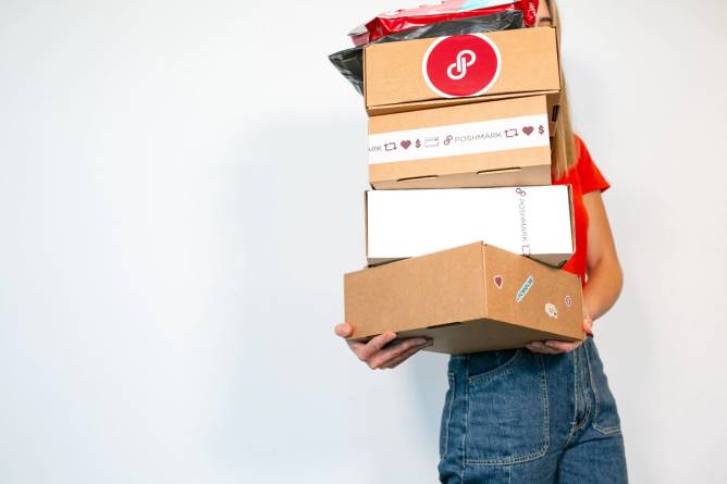 Woman holding Poshmark boxes