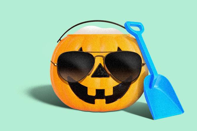 Jack o lantern with sunglasses and a toy shovel.