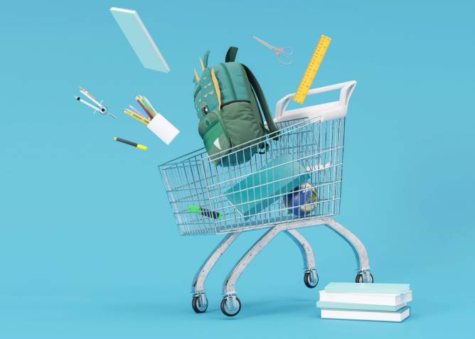 Shopping cart, trolley with school stationery items on blue background.