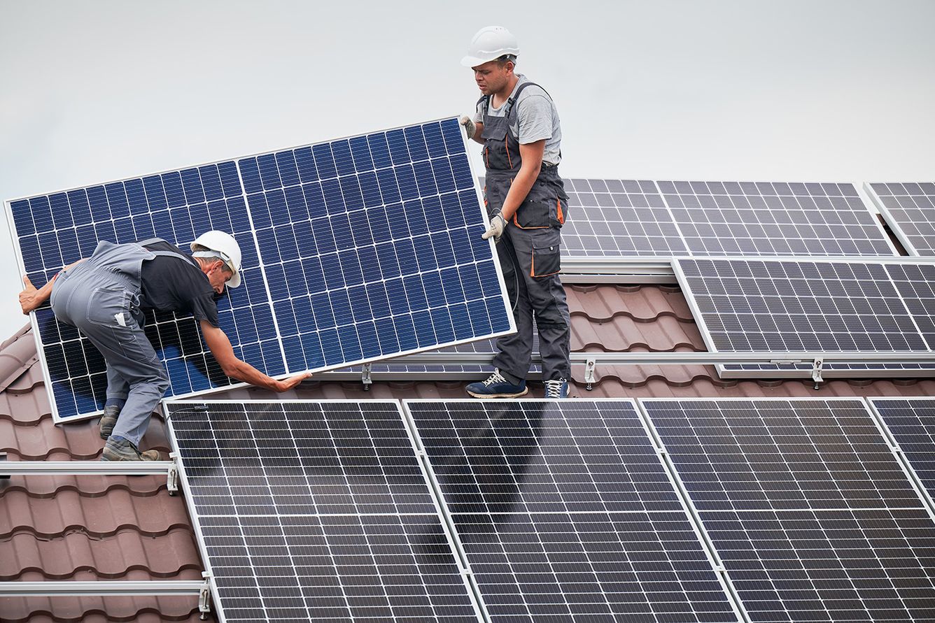 Workers install solar panels