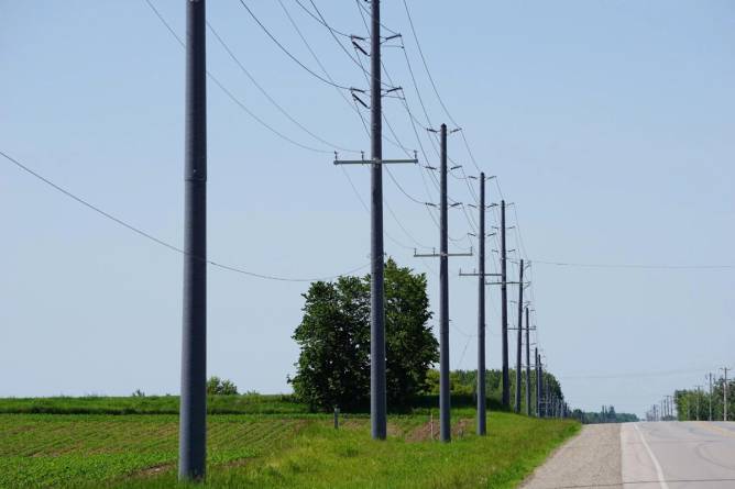 RS Technologies' utility poles along a highway. 