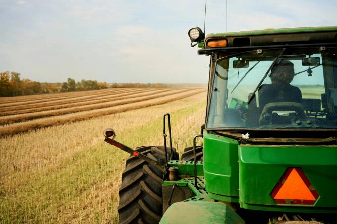 A farmer driving a tractor.