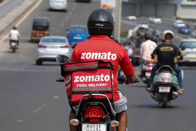 Zomato food delivery worker on scooter.