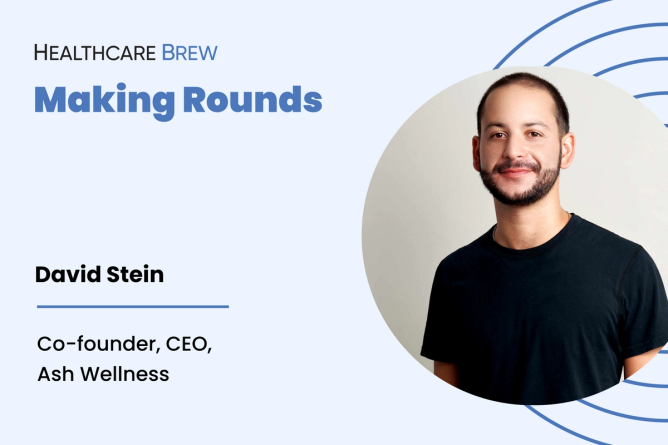 A guy with short hair and a black shirt smiles