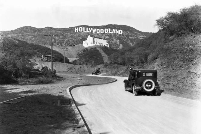 1924 photo of car approaching "Hollywoodland" sign"