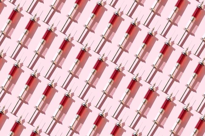 An illustration of shots with red liquid lined up against a pink background
