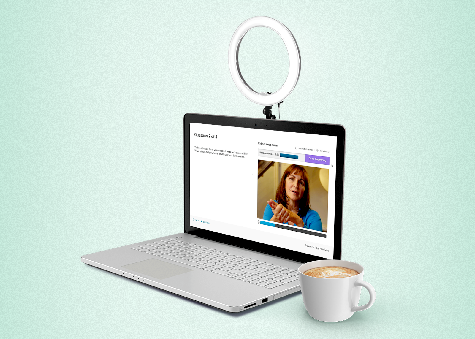 laptop with woman on virtual interview next to mug