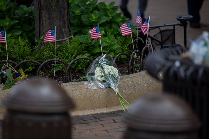 Flowers are laid near the scene of a shooting at a Fourth of July parade on July 5, 2022