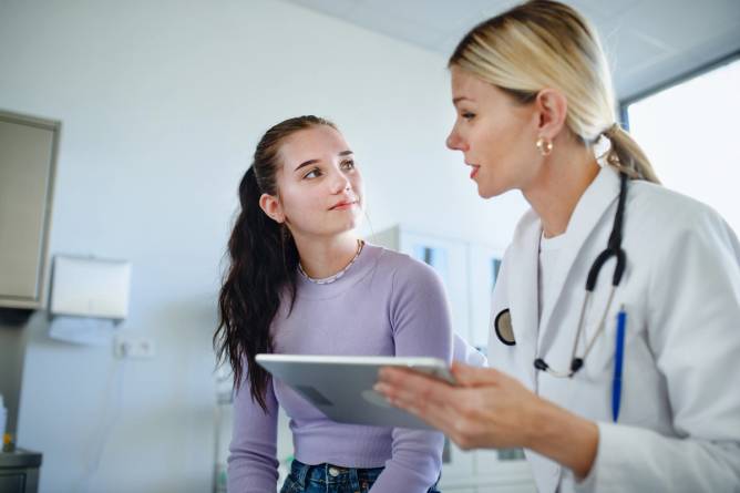 Young female doctor treats a patient