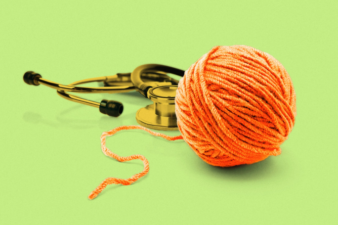 A stethoscope next to a ball of yarn unravelling