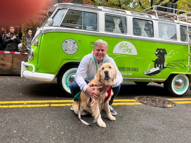 Get Joy CEO and founder Tom Arrix, poses with his dog, a golden retriever named Theo, at the Tompkins Square Halloween Dog Parade on October 21