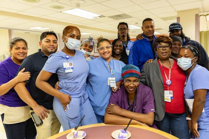 Union members smile after winning a contract.