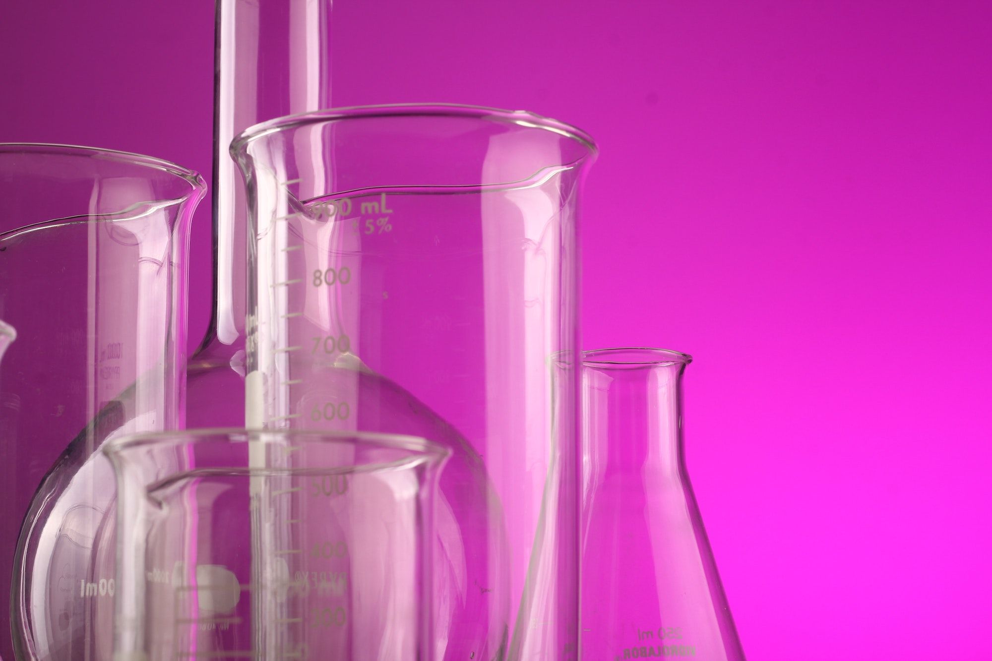 pictures of beakers with a hot pink background