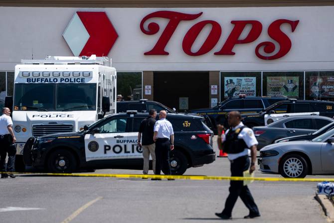 Law enforcement officials are seen at the scene of a mass shooting at Tops Friendly Market