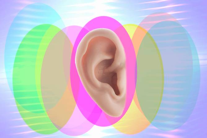 Image of an ear on a multicolored background.