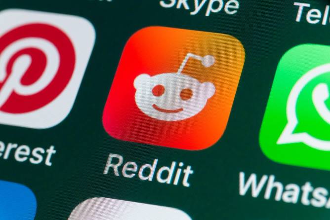a Reddit logo on a mobile phone screen