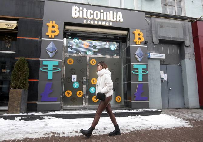 Woman walks in Ukraine in front of crypto exchange