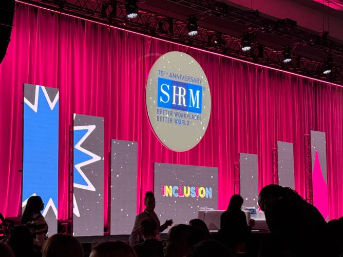 The SHRM Inclusion stage with a large pink curtain with the SHRM logo