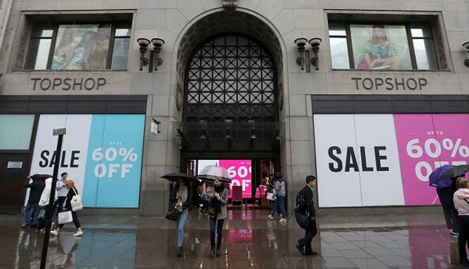 The facade of a Topshop store in London, England covered in sale signs