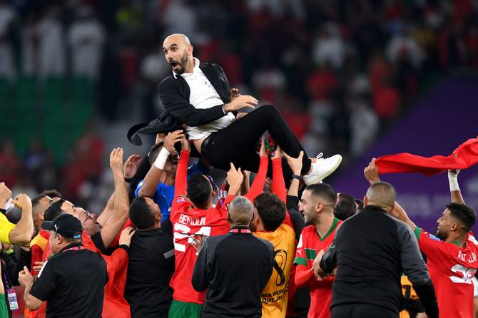 Walid Regragui, Head Coach of Morocco, celebrates with the team after the 1-0 win during the FIFA World Cup Qatar 2022 quarter final match between Morocco and Portugal