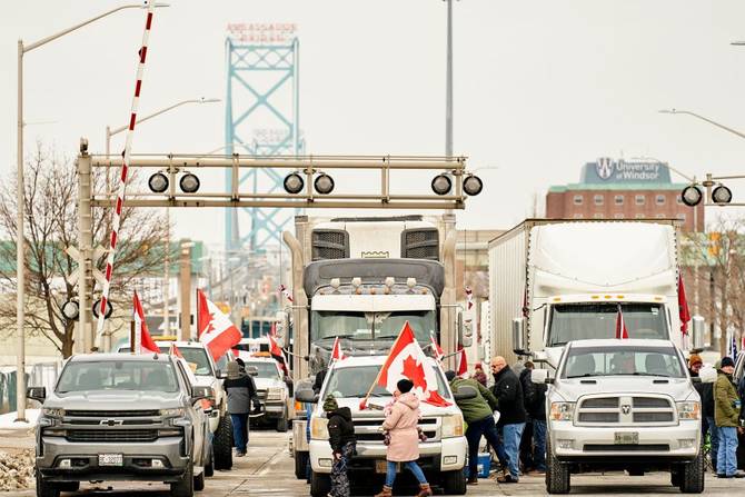 Supporters of the Truckers Convoy against the Covid-19 vaccine mandate block traffic in the Canada bound lanes of the Ambassador Bridge border crossing
