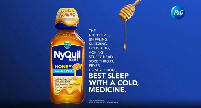 A still from a current Vicks NyQuil Severe Honey commercial depicts honey descending from a wooden dripper, as does its packaging, which has a dispenser cup shaped like a beehive.