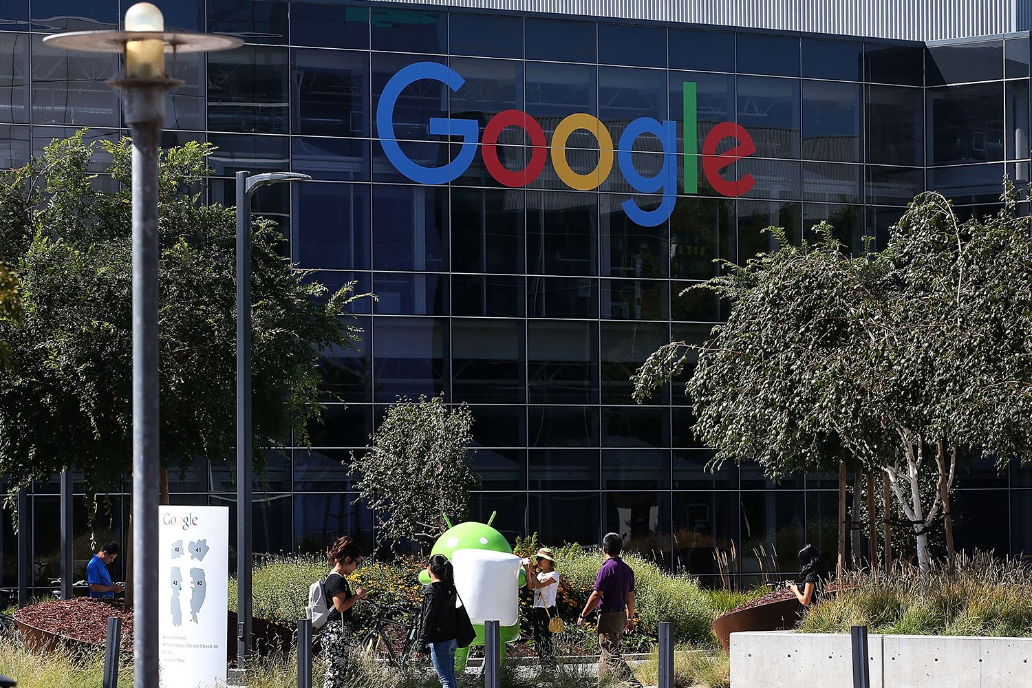 People walk by the Google corporate building