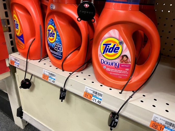 Tide laundry detergent bottles with security locking system to prevent theft at CVS pharmacy, Queens, New York.