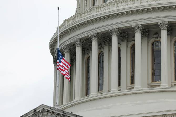 The US flag flies at half staff over the US Capitol Building to honor the one million Americans who've died from Covid. 