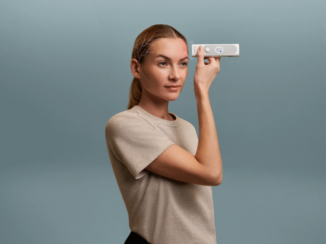 A woman uses a device to check her temperature