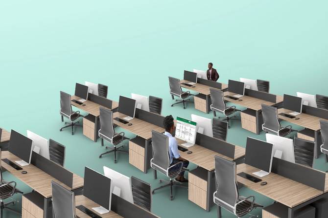 Two workers at a largely empty office. 