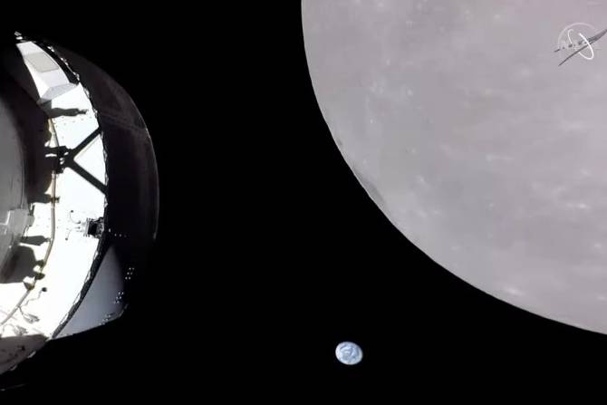 The Artemis spacecraft by the moon with the Earth small in the background