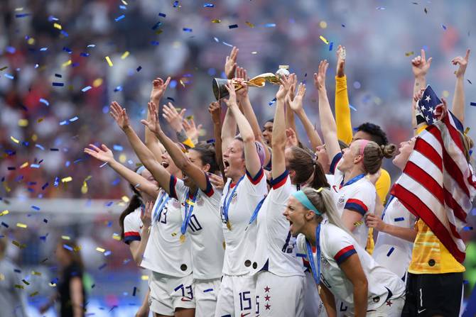 Megan Rapinoe of the USA lifts the FIFA Women's World Cup Trophy