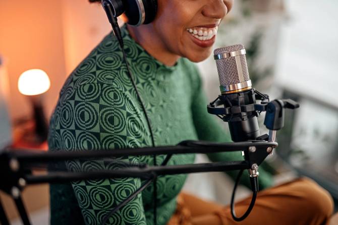 smiling woman recording a podcast