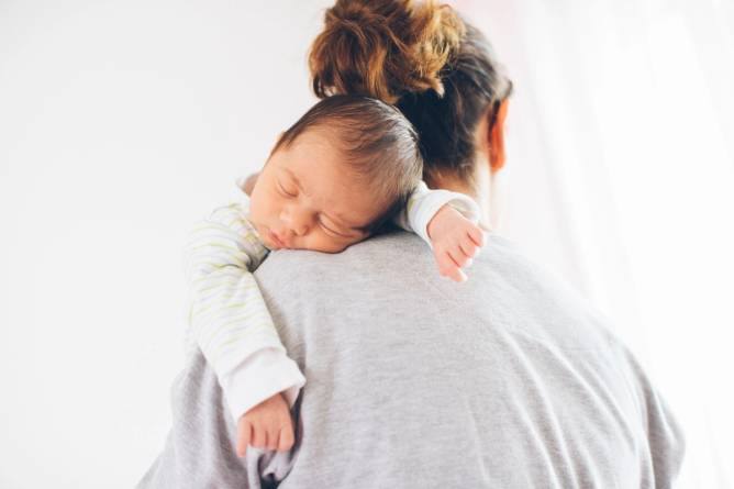 A mother holding a baby