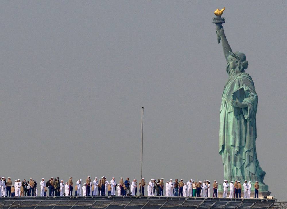 Marines passing by the statue of liberty 