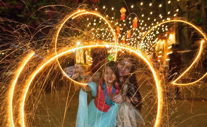 A family celebrates Diwali with firecrackers