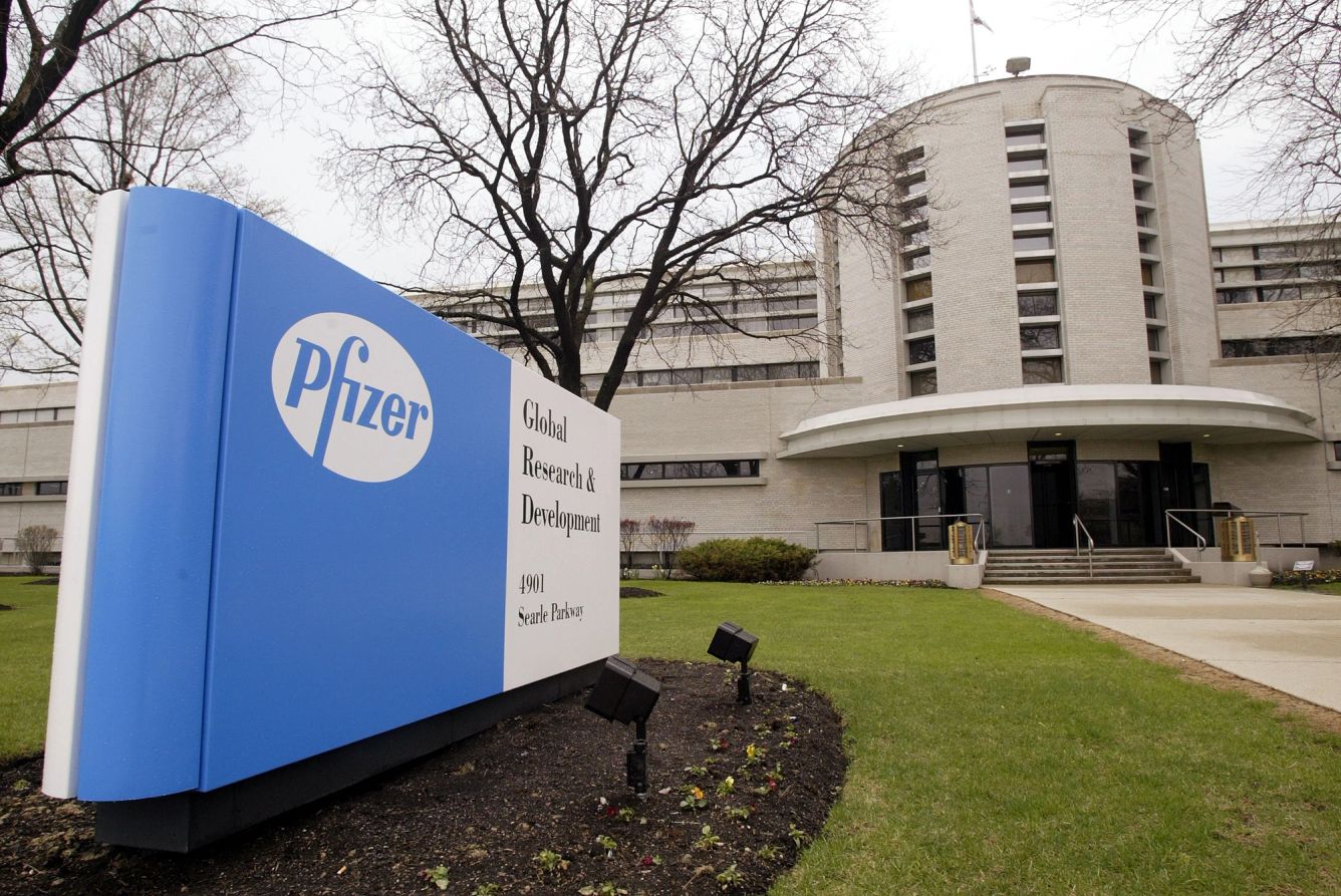 Outside of a hospital with a Pfizer sign