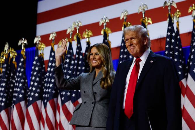 Republican presidential nominee, former U.S. President Donald Trump arrives to speak with former first lady Melania Trump during an election night event at the Palm Beach Convention Center