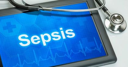 A tablet displaying the word “Sepsis” with a stethoscope laid on top of it