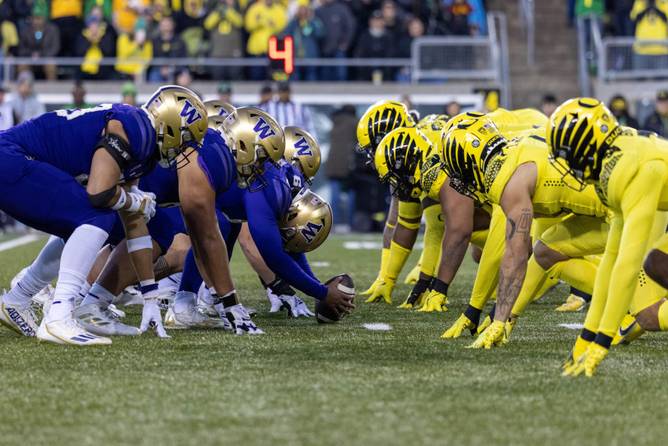 Oregon and Washington football players line up