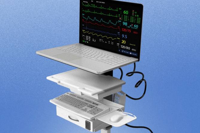 A laptop tracking vital signs is placed on rolling medical equipment. 