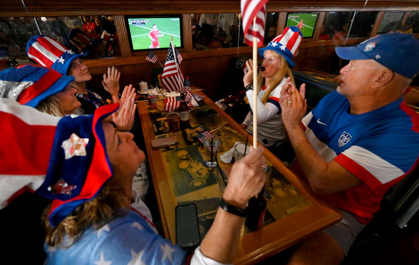 American soccer fans watch a World Cup game at a bar