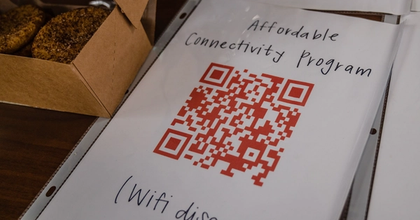 Laminated piece of paper labeled "Affordable Connectivity Program" and "WiFi discount" with a QR code in the middle